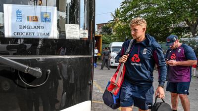 Joe Root boards the bus. AFP