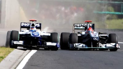 Michael Schumacher, right, came in for heavy criticism from the F1 community after squeezing Rubens Barrichello's Williams dangerously close to the wall in Hungary.