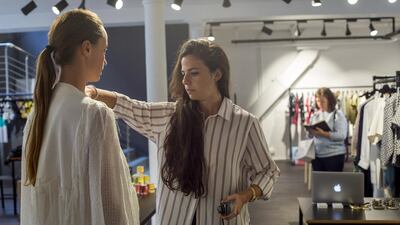 Farah Mounzer, the buying manager for Symphony, goes through new clothing lines. Photo by Marie Docher for The National