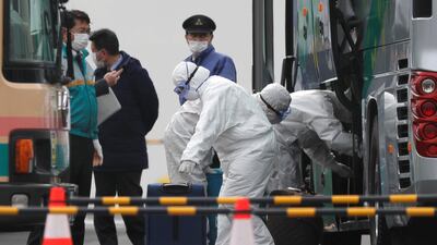 Workers load luggage into a bus as a second group of passengers from the coronavirus-hit Diamond Princess cruise ship disembark in Yokohama Port, south of Tokyo, Japan, February 20, 2020. REUTERS/Kim Kyung-Hoon