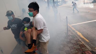 Anti-government protesters run away from tear gas during a march against Beijing’s plans to impose national security legislation in Hong Kong. Reuters