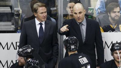 Pittsburgh Penguins' Mike Johnston, left, listens to assistant coach Rick Tocchet as he gives instructions during an NHL hockey game against the Los Angeles Kings in Pittsburgh Friday, Dec. 11, 2015. The Kings won 3-2 in a shootout. (AP Photo/Gene J. Puskar)