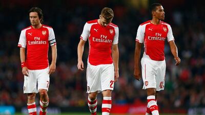Tomas Rosicky of Arsenal, Calum Chambers of Arsenal and Isaac Hayden of Arsenal look down during their League Cup third round loss to Southampton at the Emirates Stadium on Tuesday night. Julian Finney / Getty Images / September 23, 2014