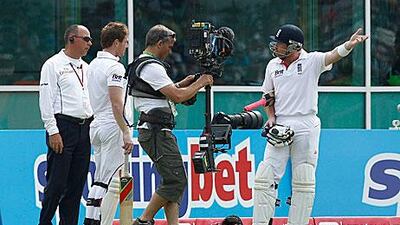 England's Ian Bell, right, reacts after being controversially given out for walking from the pitch.