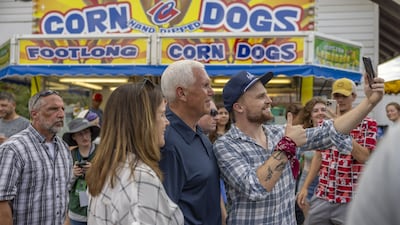 Former US vice president Mike Pence takes a selfie in front of a corn dog stand at the Iowa State Fair in Des Moines, Iowa. Bloomberg