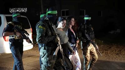 Israeli hostages being handed over to the International Red Cross by Hamas militants on November 30. Reuters