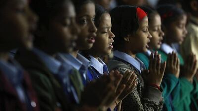 India schoolgirls in Mumbai pray. Rafiq Maqbool / AP Photo