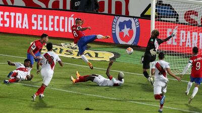 Chile's Arturo Vidal, centre above, scores his side's second goal in their 2-0 victory against Peru during the World Cup qualifier in Santiago on Friday, November 13. AP