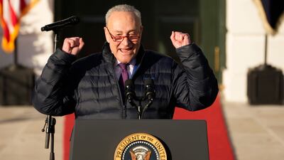 Mr Schumer celebrates the signing. AP