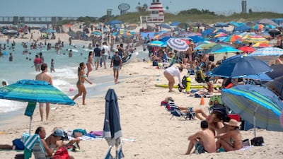 People enjoy a warm day at the beach in Miami Beach, Florida, US. Florida reported 15,300 coronavirus cases, on Sunday a record single-day surge anywhere in the US. EPA
