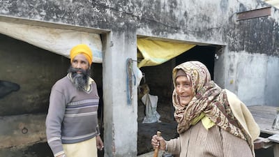 Gurmeet Kaur with her son's friend Balwinder Singh. Neighbours and relatives have stepped in to help families of farmers who are at the protests.