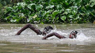 Children swim in a canal on a hot summer afternoon in New Delhi. AFP