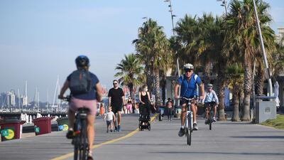 People walk and cycle at St. Kilda Beach in Melbourne, Australia. Melbourne, Australia's second-largest city, will relax its third lockdown restrictions after authorities contained the spread of a COVID-19 cluster centered on hotel quarantine. AP Photo