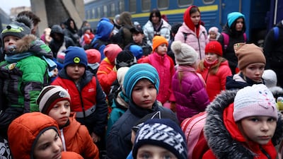 A group of children from an orphanage in Zaporizhzhia wait to board a bus to Poland after fleeing the Russian onslaught, Ukraine, March 5, 2022. Reuters