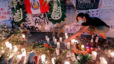 People pay tribute with flowers and cards during a candlelight vigil in Lima in memory of Inti Sotelo, 24, and Jack Pintado, 22, who were wounded and later reported dead, during clashes against police while protesting the government of interim President Manuel Merino, in downtown Lima, Peru. AFP