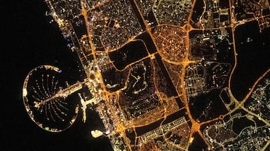 The photo shows Palm Jumeirah, Jebel Ali Industrial area and large parts of residential areas in Dubai. Sultan Al Neyadi