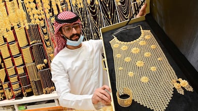 A merchant displays jewellery at his shop in Dubai's Gold Souk. AFP