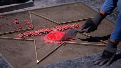 Workers replace the Star of US President Donald Trump on the Hollywood Walk of Fame after it was destroyed by a vandal. The city council of West Hollywood has asked that the Star on the Hollywood Walk of Fame for Donald Trump be removed, in part because of the way he treats women AFP