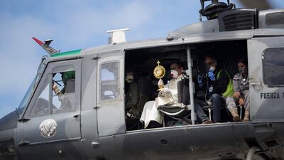 Two priests fly over Santo Domingo, Dominican Republic, in a helicopter, carrying the Blessed Sacrament to ask God for the end of the coronavirus pandemic. EPA