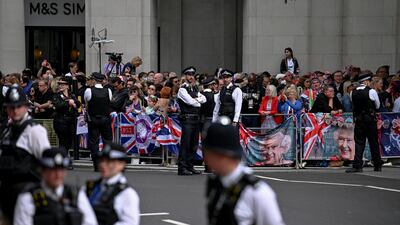 Police officers stand guard as people gather outside St Paul's Cathedral. Reuters