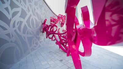 The sculpture is mostly constructed with pink stainless steel.
