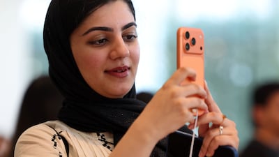 A woman tests the iPhone 17