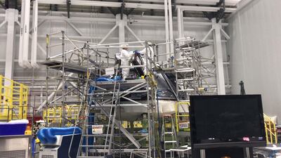 Boeing technicians and engineers completing work on the CST-100 Starliner ahead of its unmanned orbital test flight Dec. 17. Deena Kamel/The National.