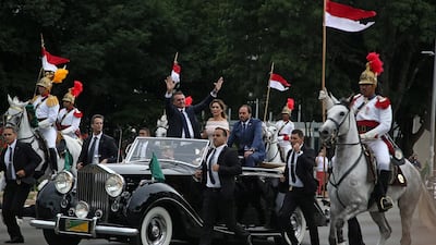 Brazil's President-elect Jair Bolsonaro waves to the crowd as he arrives with his wife Michelle to his inauguration ceremony. Reuters