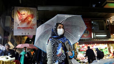 An Iranian woman wears a protective face mask and gloves. Reuters