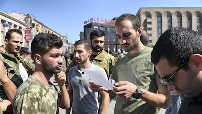 People attend a meeting to recruit military volunteers after Armenian authorities declared martial law and mobilised its male population following clashes with Azerbaijan over the breakaway Nagorno-Karabakh region in Yerevan, Armenia. Reuters