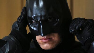 Chibatman adjusts his mask before going on the road on his Chibatpod.