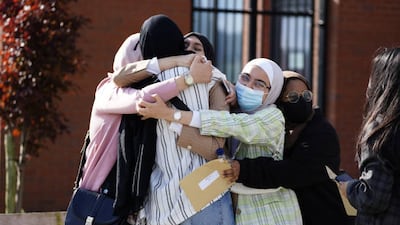 Students at Archbishop Blanch School in Liverpool congratulate one another after receiving their A-level results.