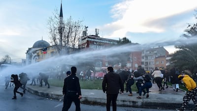Police use a water canon to disperse students. AP Photo