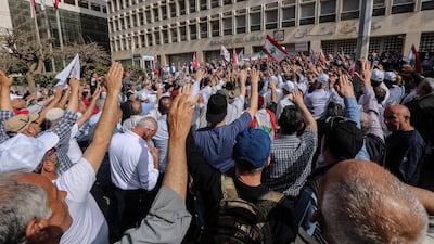 Retired army officers and soldiers carry Lebanese flags as they block the Lebanese Central Bank during a protest in Beirut 30 April 2019 as a preemptive strike against any austerity measures in the 2019 draft state budget that might affect their retirement wages or benefits. EPA