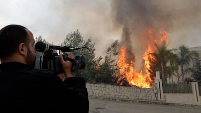 A cameraman films a fire near a house in Mechref area south Beirut, Lebanon. EPA