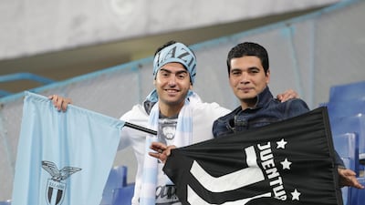 Supporters cheer from the stands. EPA