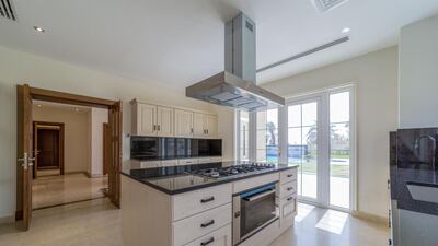 The kitchen comes with stainless steel appliances with oven located on a central island. Courtesy LuxuryProperty.com