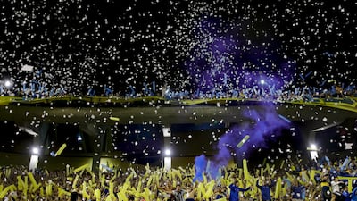 Fans of Boca Juniors cheer amid confetti during the Copa Libertadores semifinal second leg soccer match against River Plate at La Bombonera stadium in Buenos Aires, Argentina, Tuesday, Oct. 22, 2019. (AP Photo/Natacha Pisarenko)