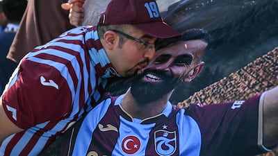 A Trabzonspor supporter kisses a tifo of Egyptian forward Mohamed Salah. AFP