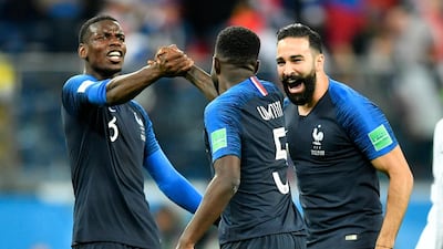 France's Paul Pogba, left, celebrates with Samuel Umtiti and Adil Rami after their team advanced to the World Cup final against Belgium. AP Photo
