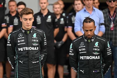 Mercedes drivers Lewis Hamilton and George Russell observe a minute's silence before the first practice session. AFP