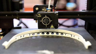 The face masks are a printed face shield, connected to a headband. Pawan Singh / The National