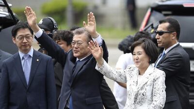 South Korea's new president Moon Jae-in waves to supporters with his wife Kim Jung-sook upon their arrival outside the presidential Blue House in Seoul, South Korea on May 10, 2017. Lee Jin-man/AP Photo