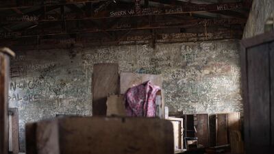 Graffiti inside a dormitory at the Government Science College, in Kagara, where gunmen kidnapped 42 people. Many pupils managed to escape in the confusion when the kidnappers arrived. AFP