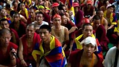 Tibetan monks gather in prayer outside a makeshift tent housing those who are fasting in protest over the Beijing Olympics.