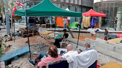 Protesters camp at the entrance of a bank in Beirut on November 1, 2019. AFP