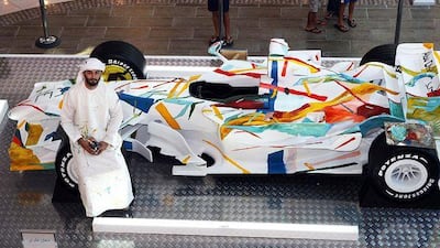 Wasel Safwan with the full-size replica of an F1 car at Marina Mall.