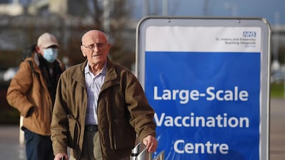 People arrive at Totally Wicked Stadium home of St Helen's rugby club as it opens as a Covid-19 mass vaccination centre in St Helen's, northwest England on January 18, 2021. AFP