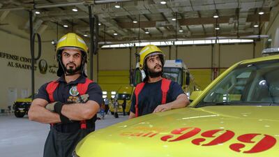 Juma Saeed Al Nuaimi, 32, and Nawaf Al Nahdi, 26, with a fast response vehicle in the fire station's garage