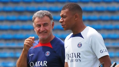 Paris Saint-Germain striker Kylian Mbappe chats with head coach Christophe Galtier. AFP